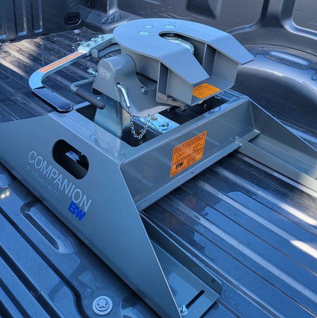 A gray B&W Companion 5th wheel hitch installed in a truck bed.