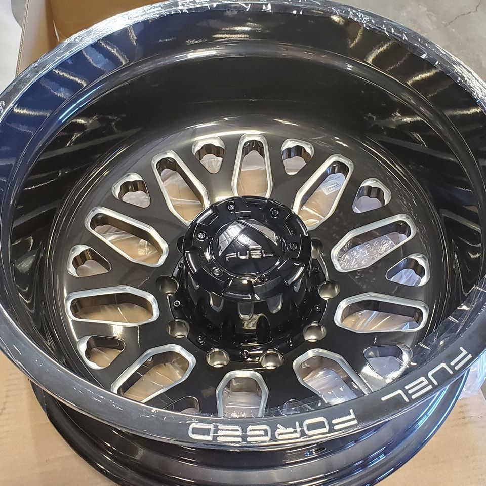 Black and silver Fuel Forged wheel with oval cutouts and center cap.