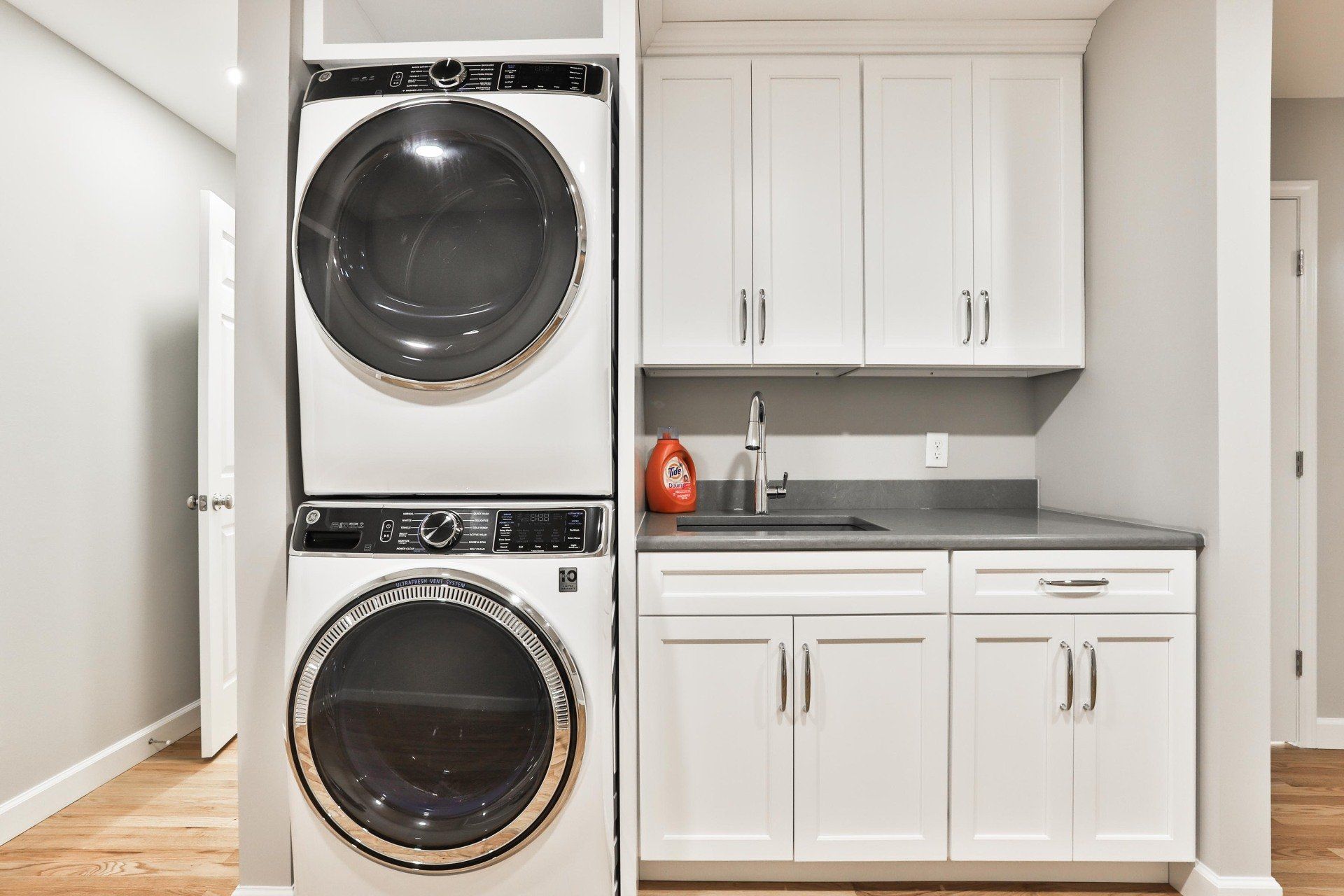 Laundry room with white cabinets
