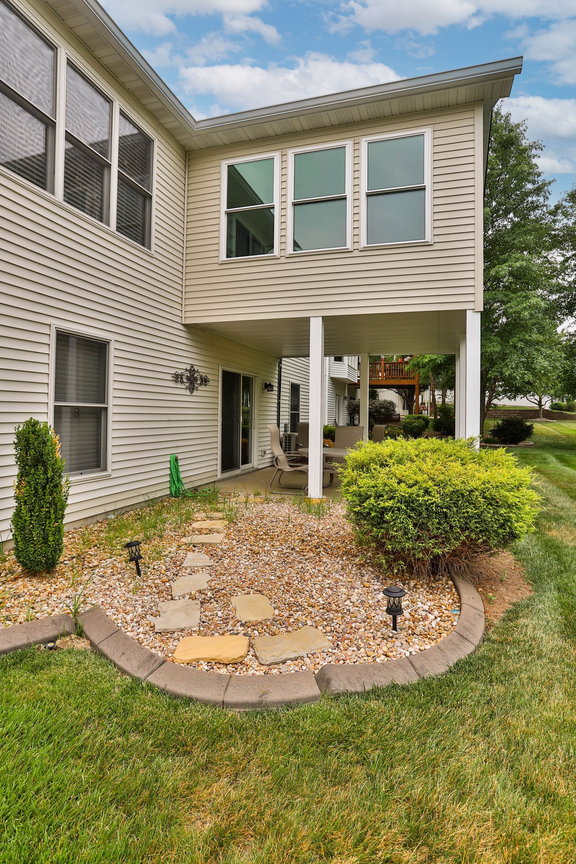 A house with a covered patio and a lot of windows