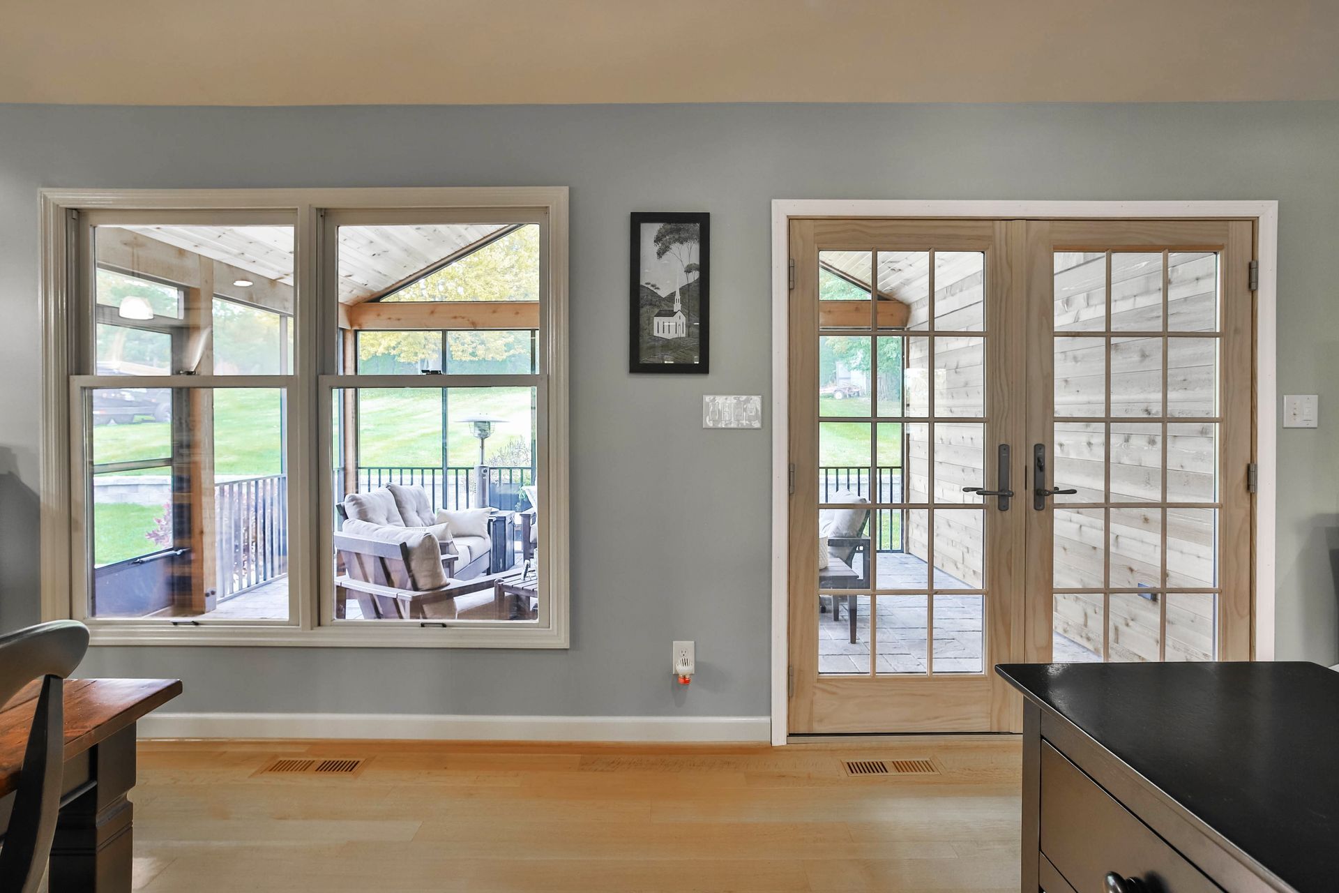 A kitchen with a lot of windows and french doors