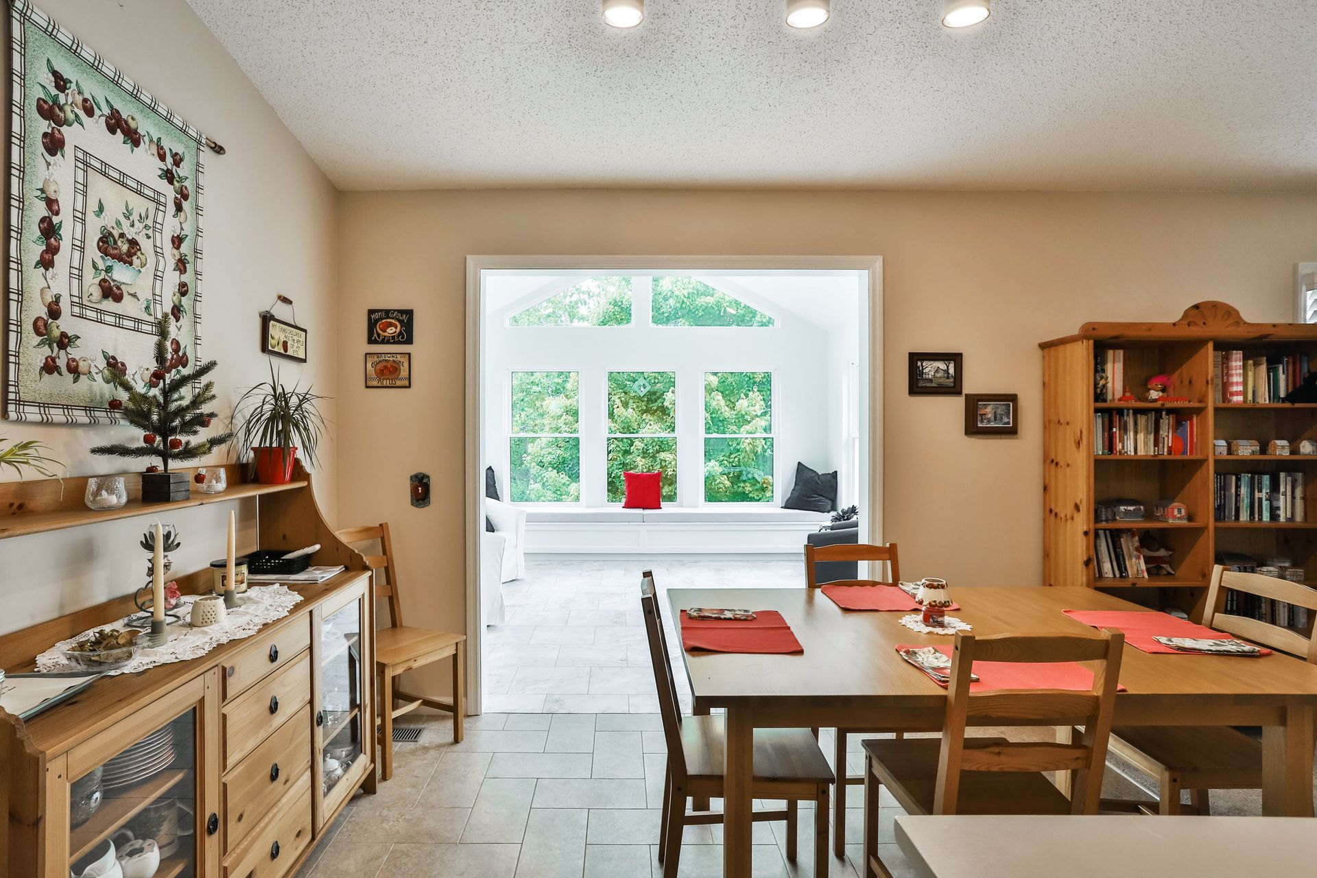 A dining room with a table and chairs and a window