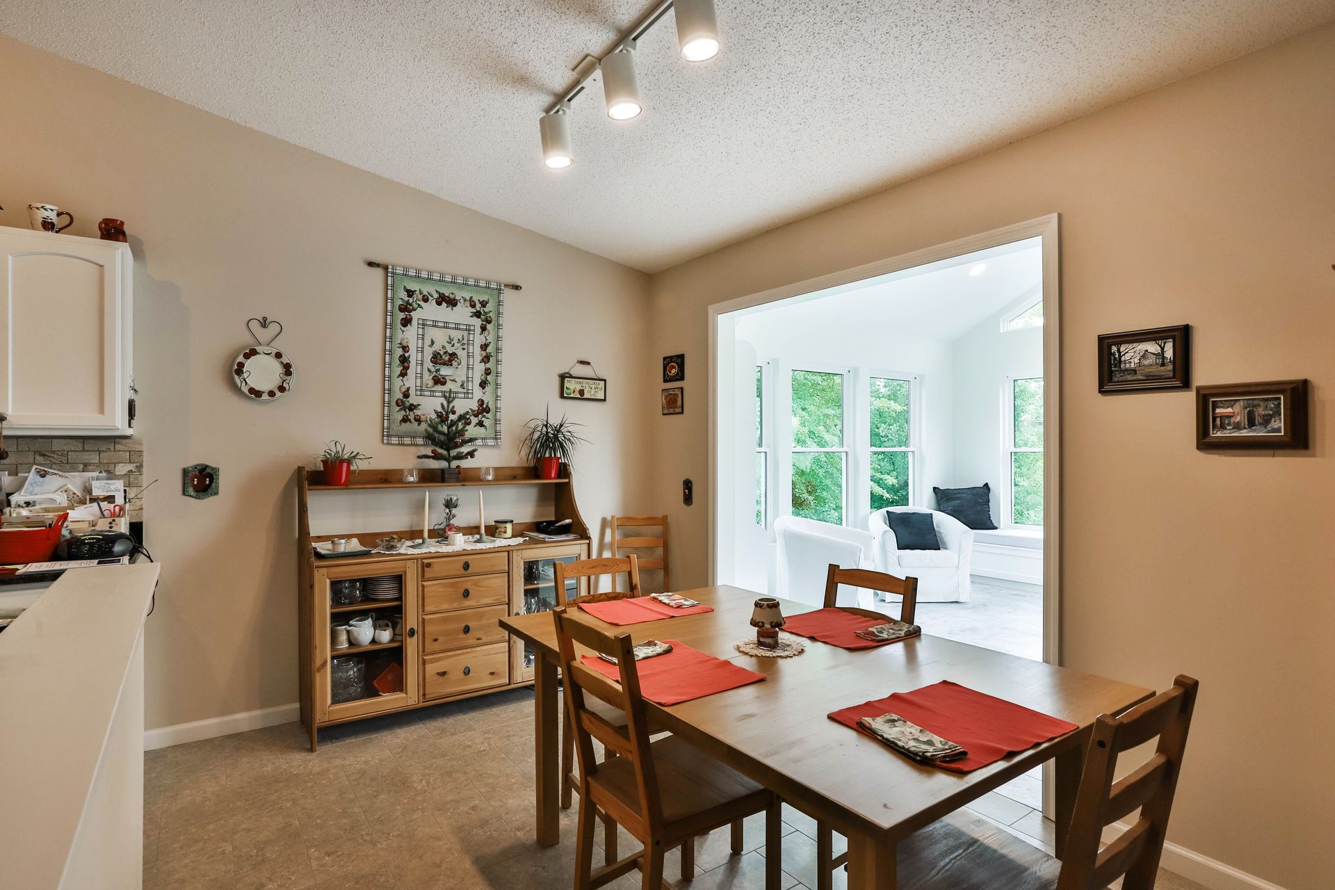 A dining room in a house with a table and chairs