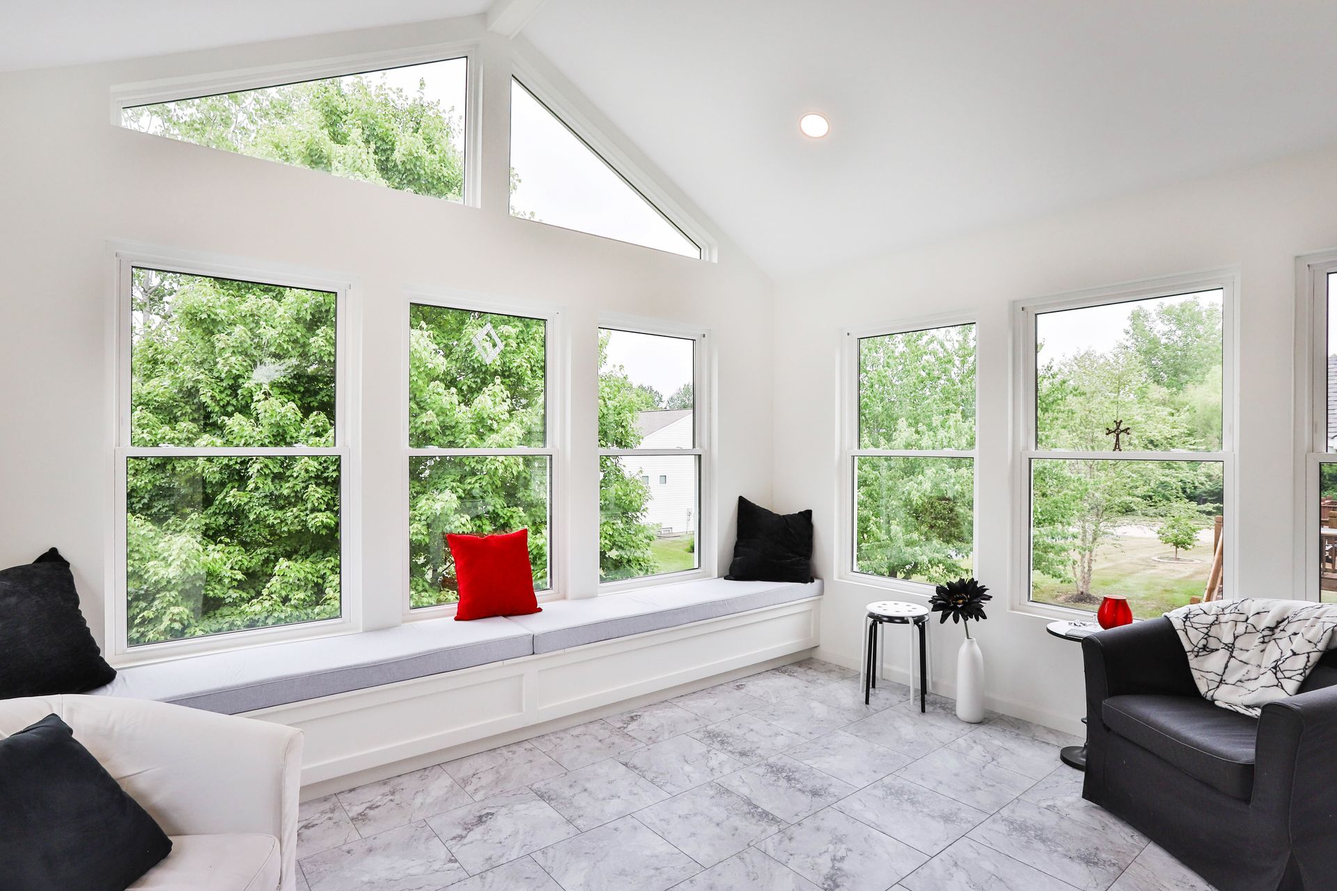 A room with a lot of windows and a couch