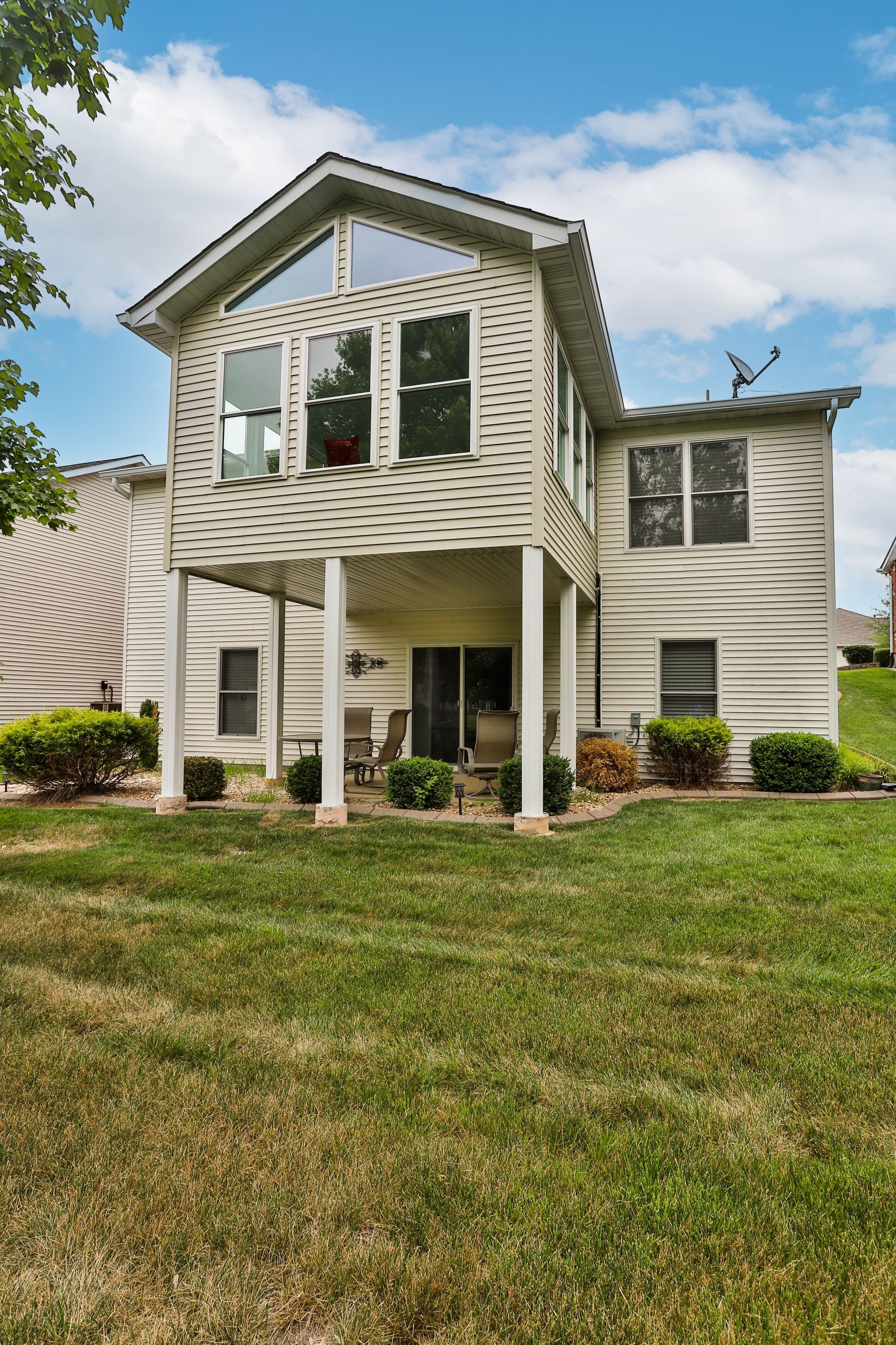 A house with a large lawn in front