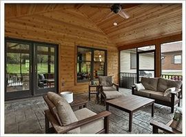 A screened-in porch with furnitures