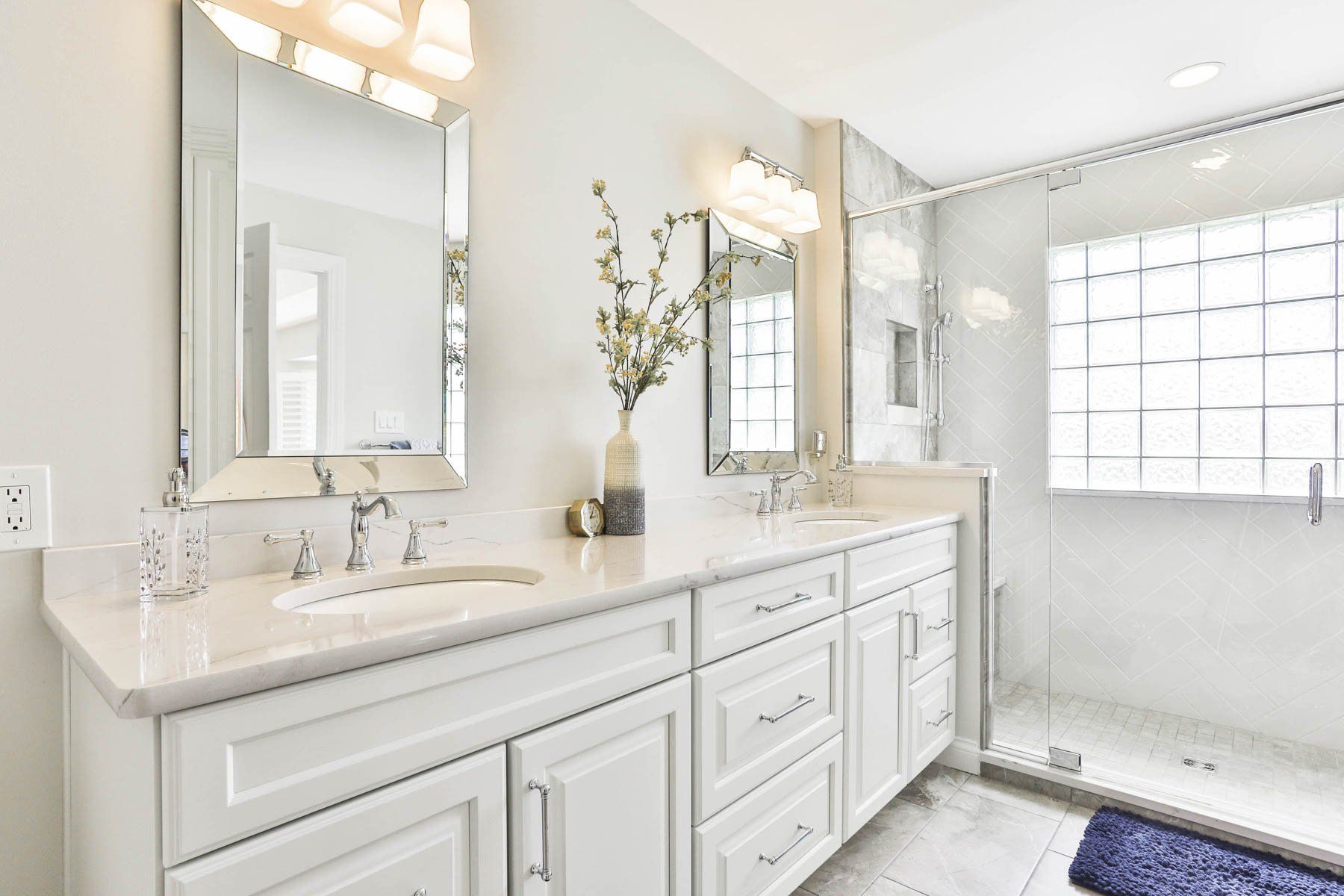 Bathroom sink and shower with glass enclosure