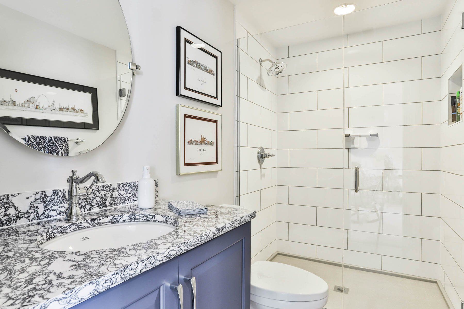 Bathroom sink and shower with glass enclosure