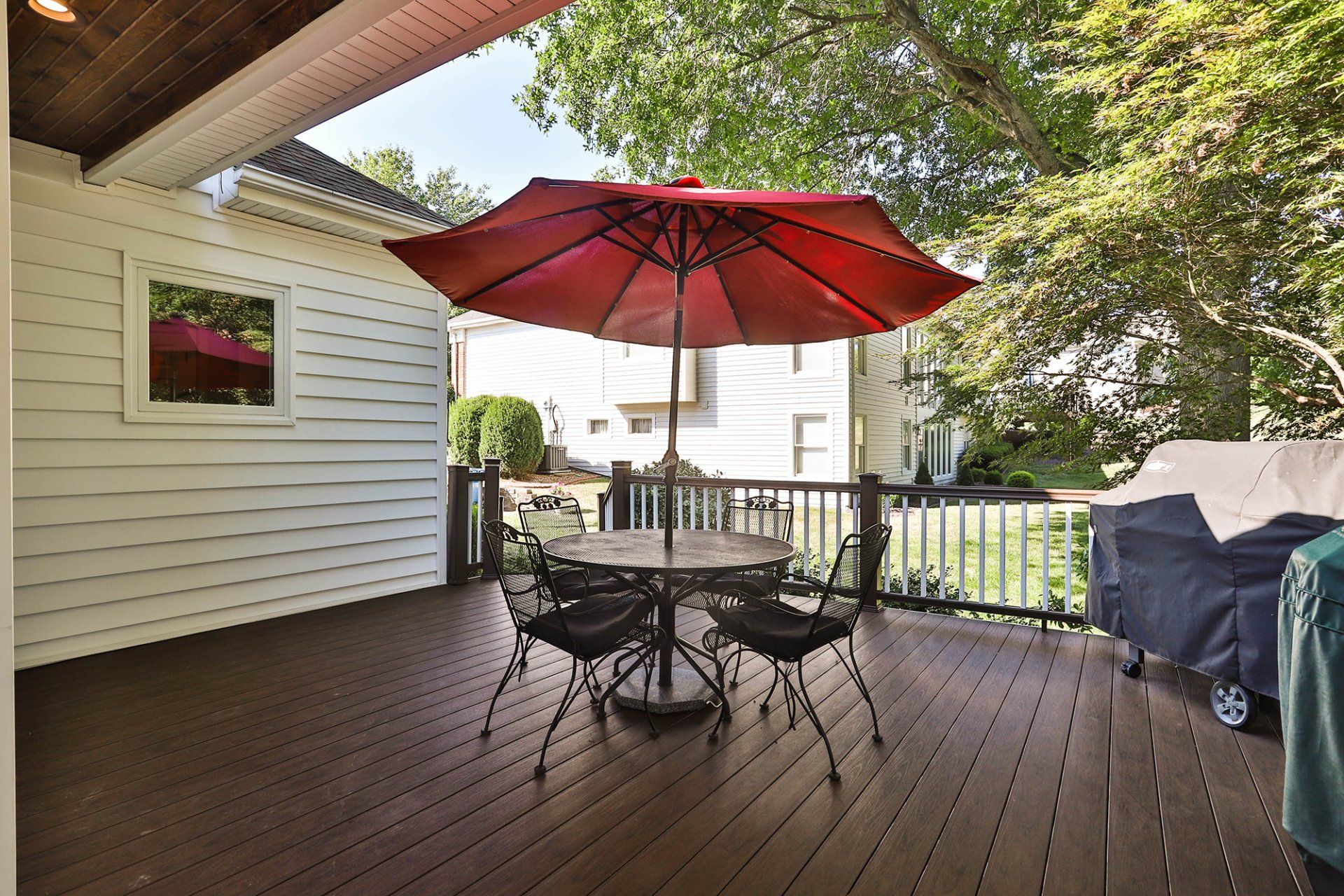 Lovely deck design with a round outdoor table set