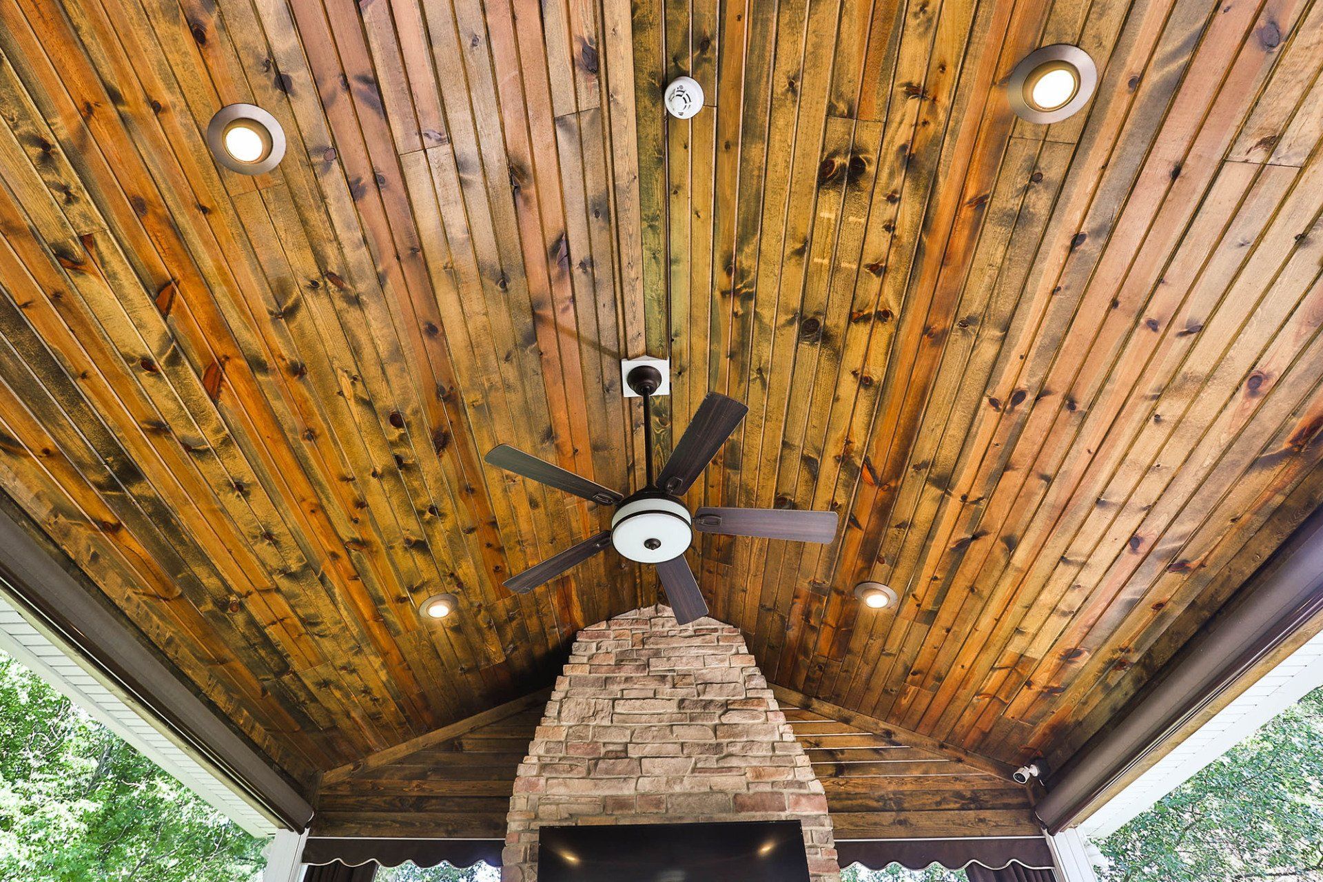 Ceiling of a backyard deck with a fireplace