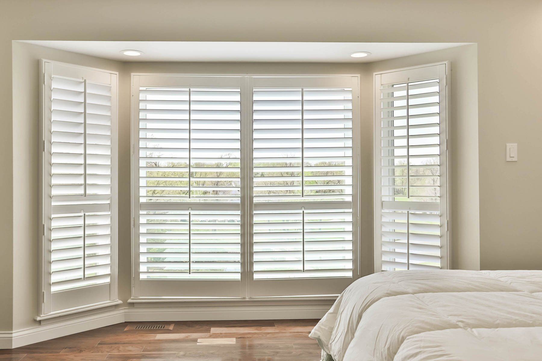 Bedroom with large wood jalousie windows