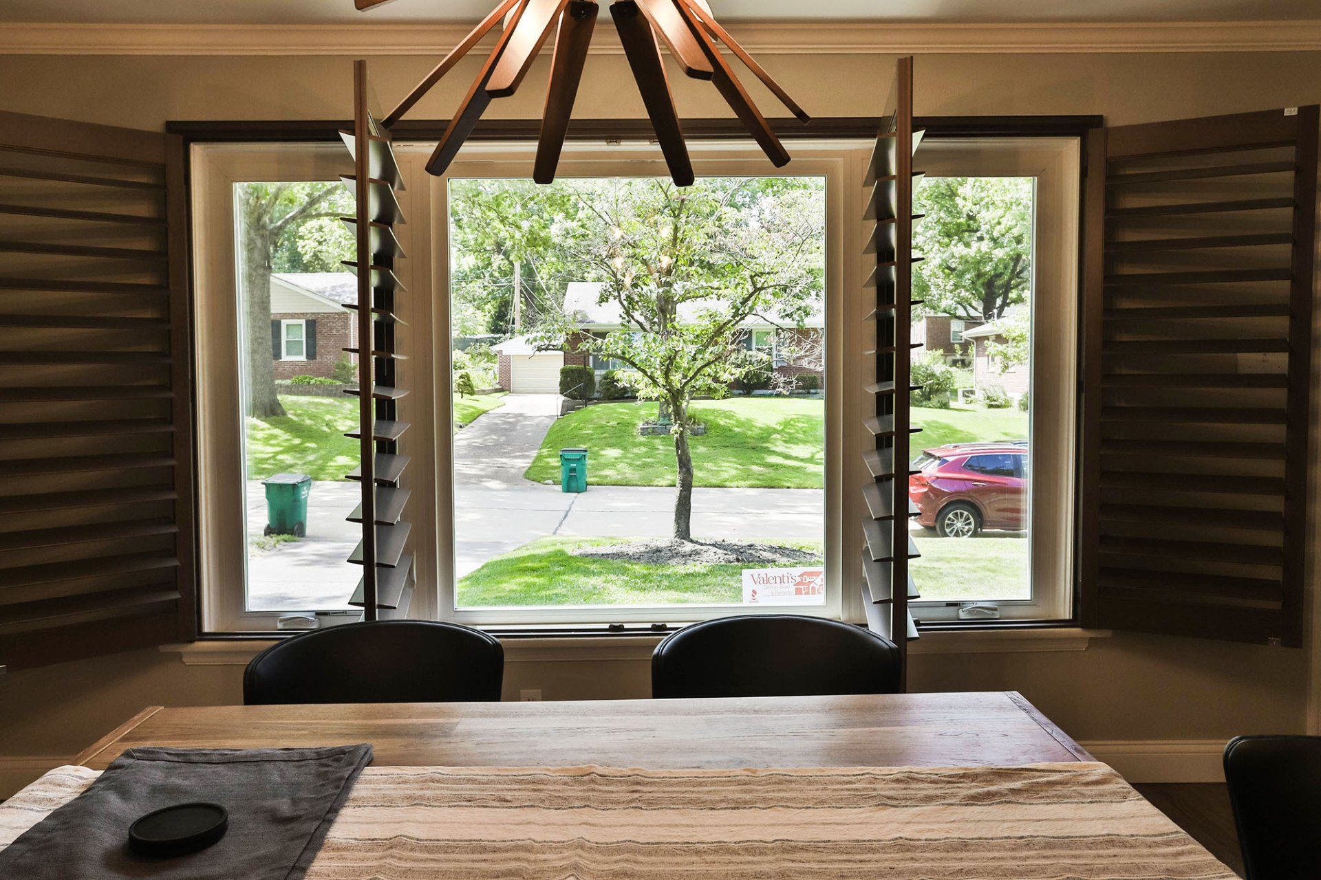 Large glass window with adjustable shutters