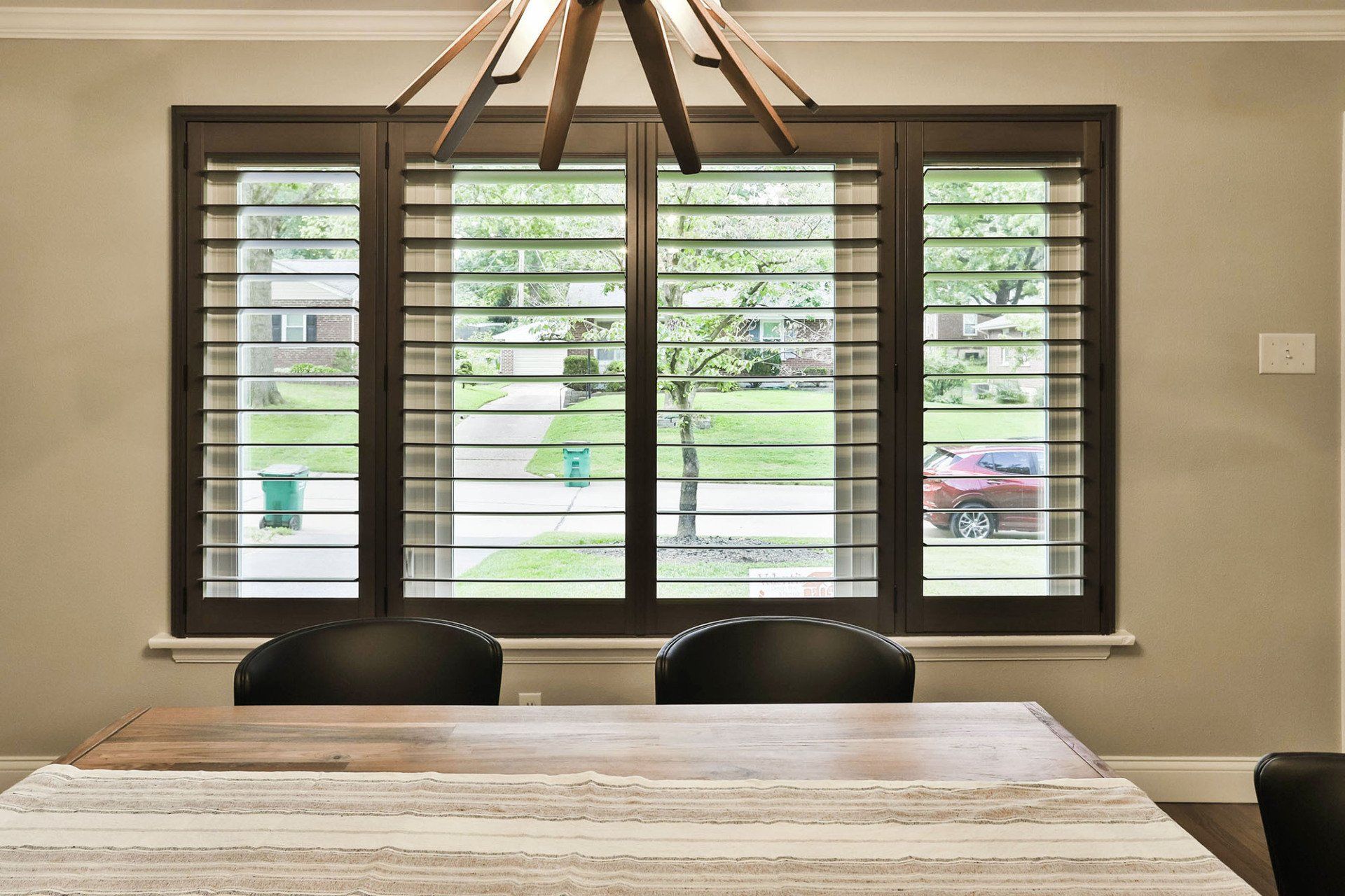 Large glass window with adjustable shutters