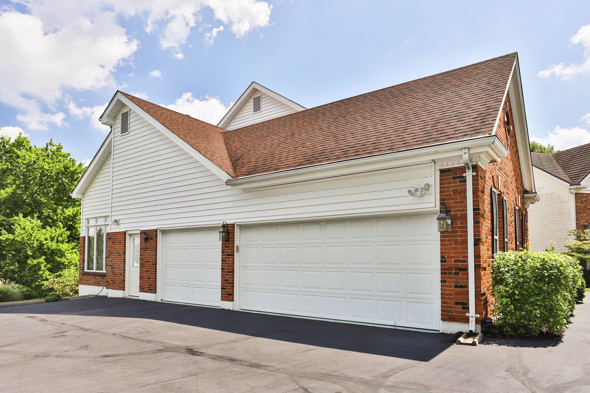 Residential garage with beige vinyl siding