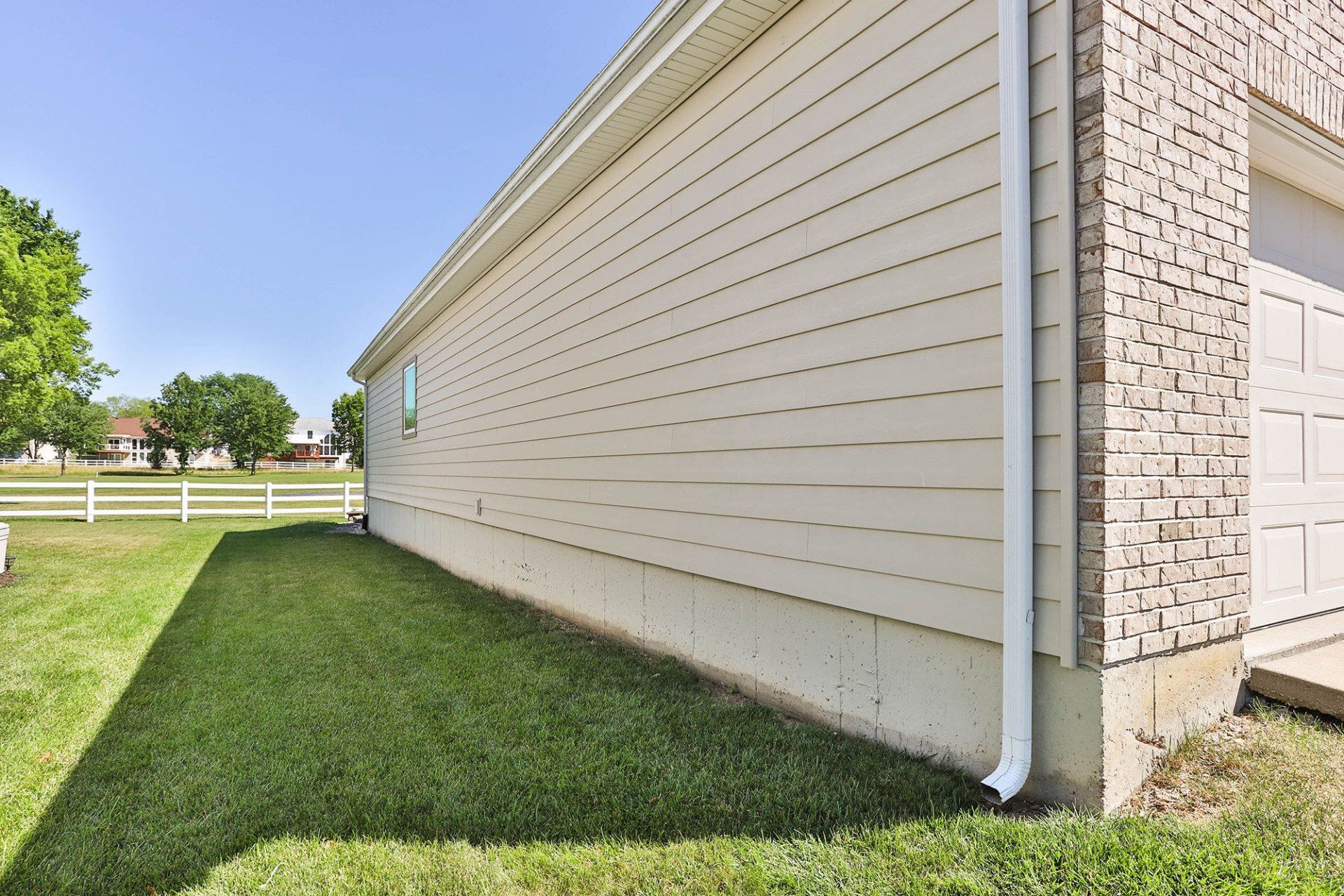 Side of a house with beige vinyl siding