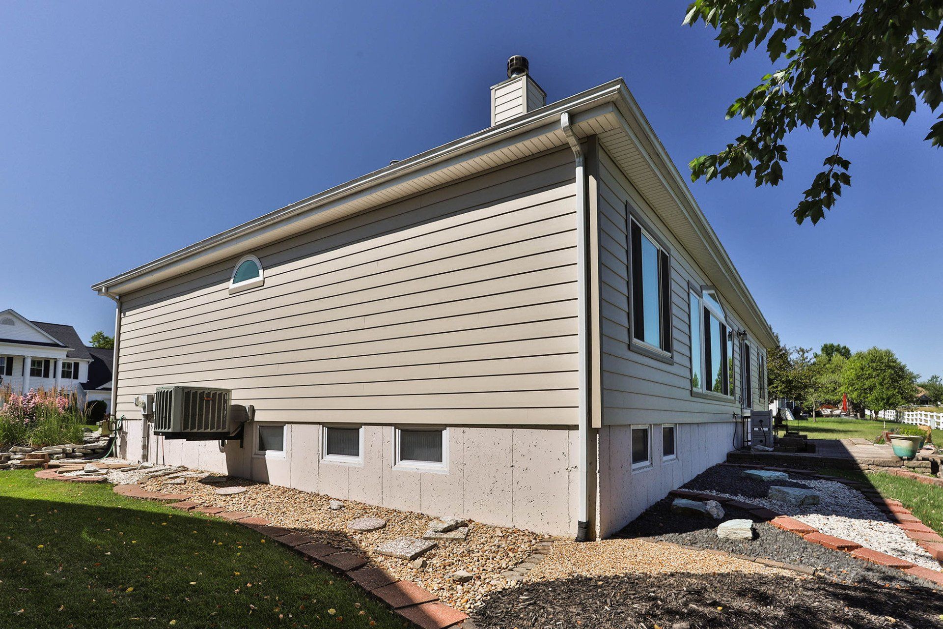 Side of a house with beige vinyl siding