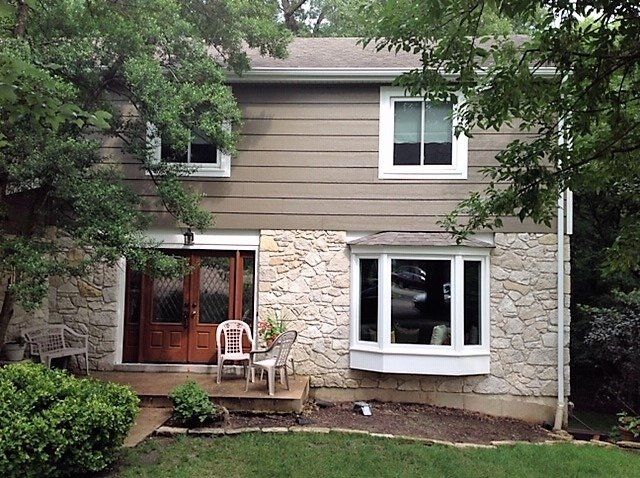 House with a siding installed on the upper floor