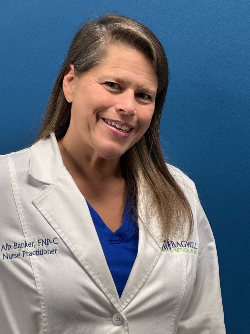 A woman in a white lab coat is smiling for the camera.