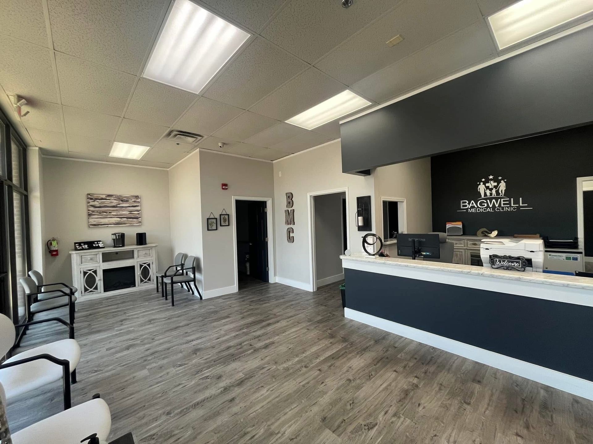 A large waiting room with a reception desk and chairs.