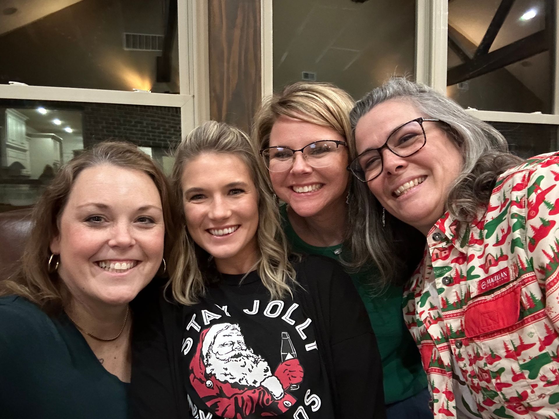 A group of four women are posing for a picture together.