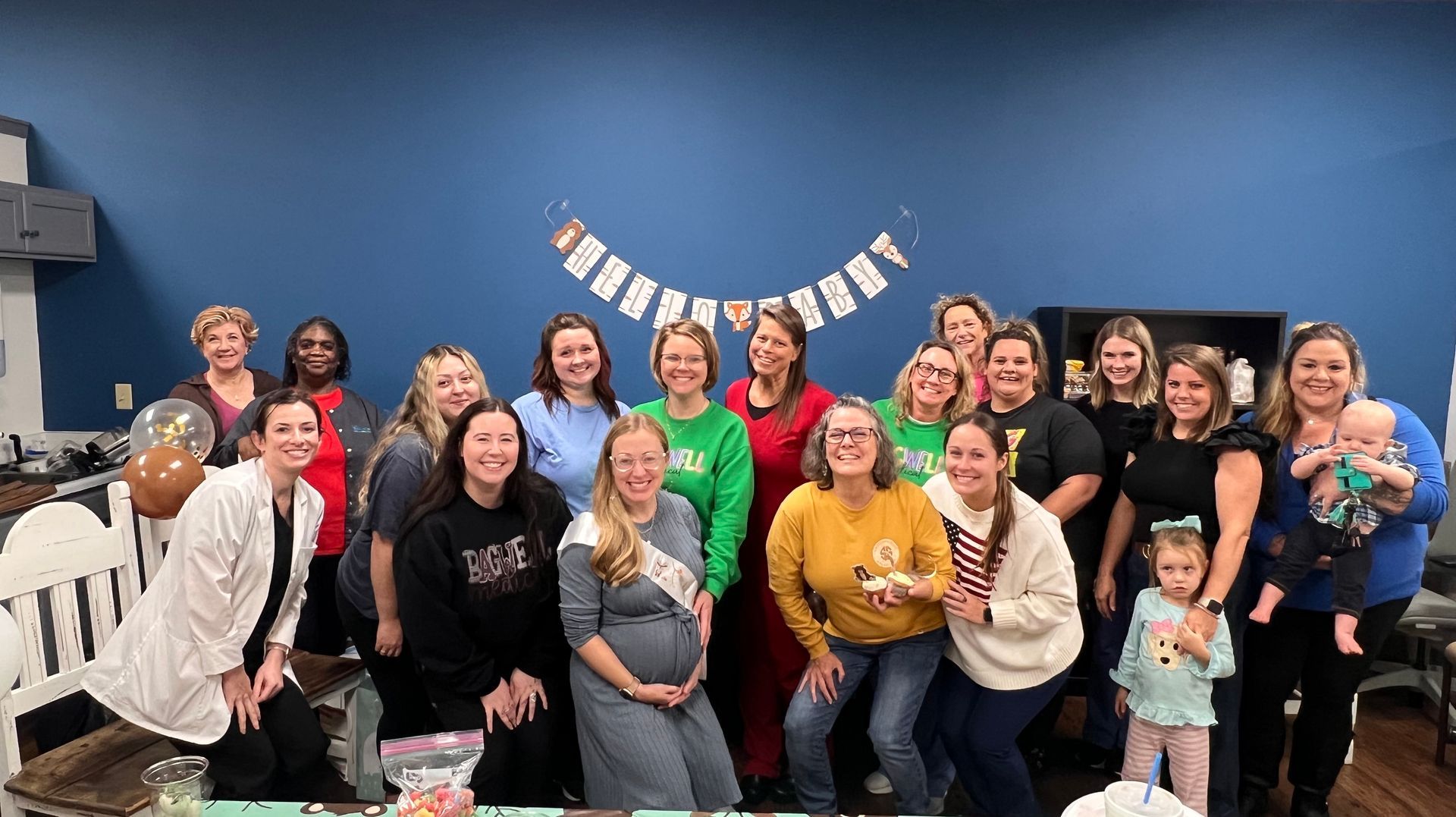 A group of women are posing for a picture at a baby shower.