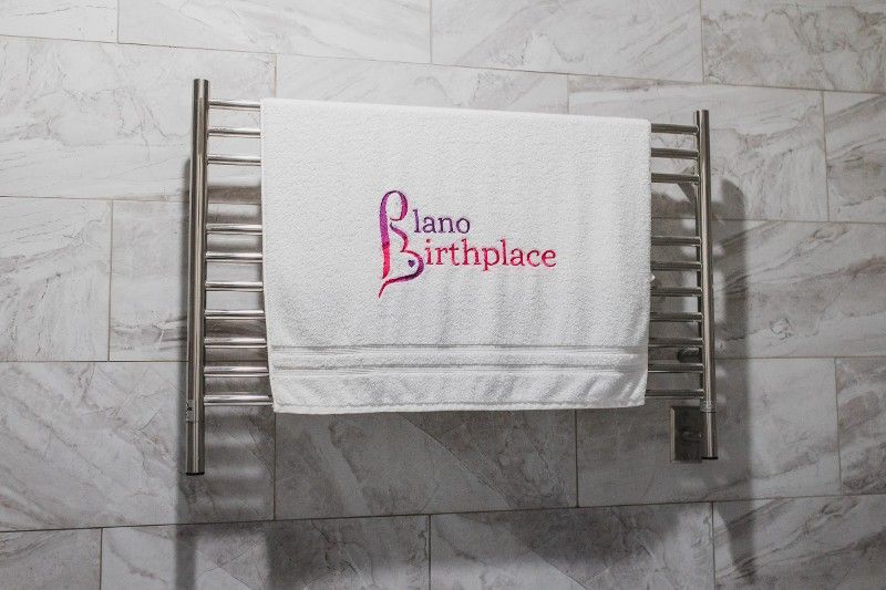 A towel hanging on a towel rack that says piano birthplace