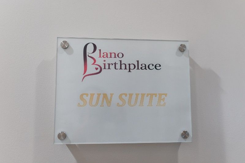 A sign on a wall that says plano birthplace sun suite