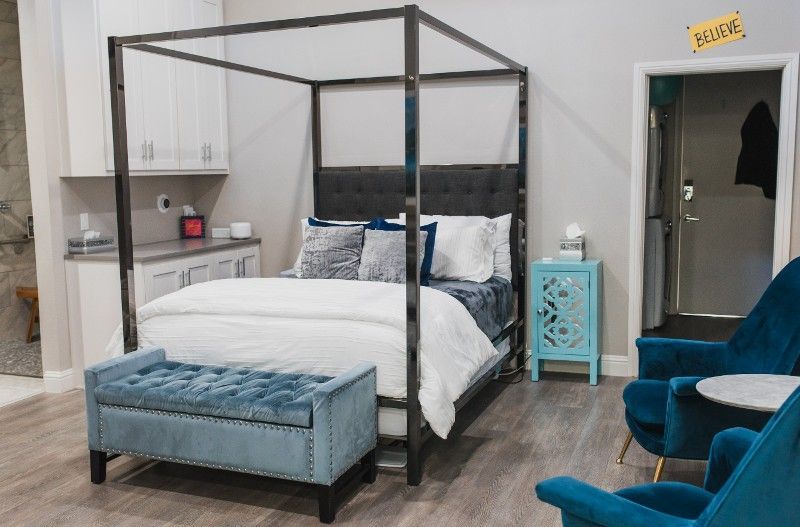 There is a four poster bed in the middle of the room.