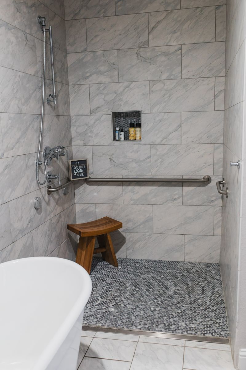 A bathroom with a walk in shower and a bathtub.