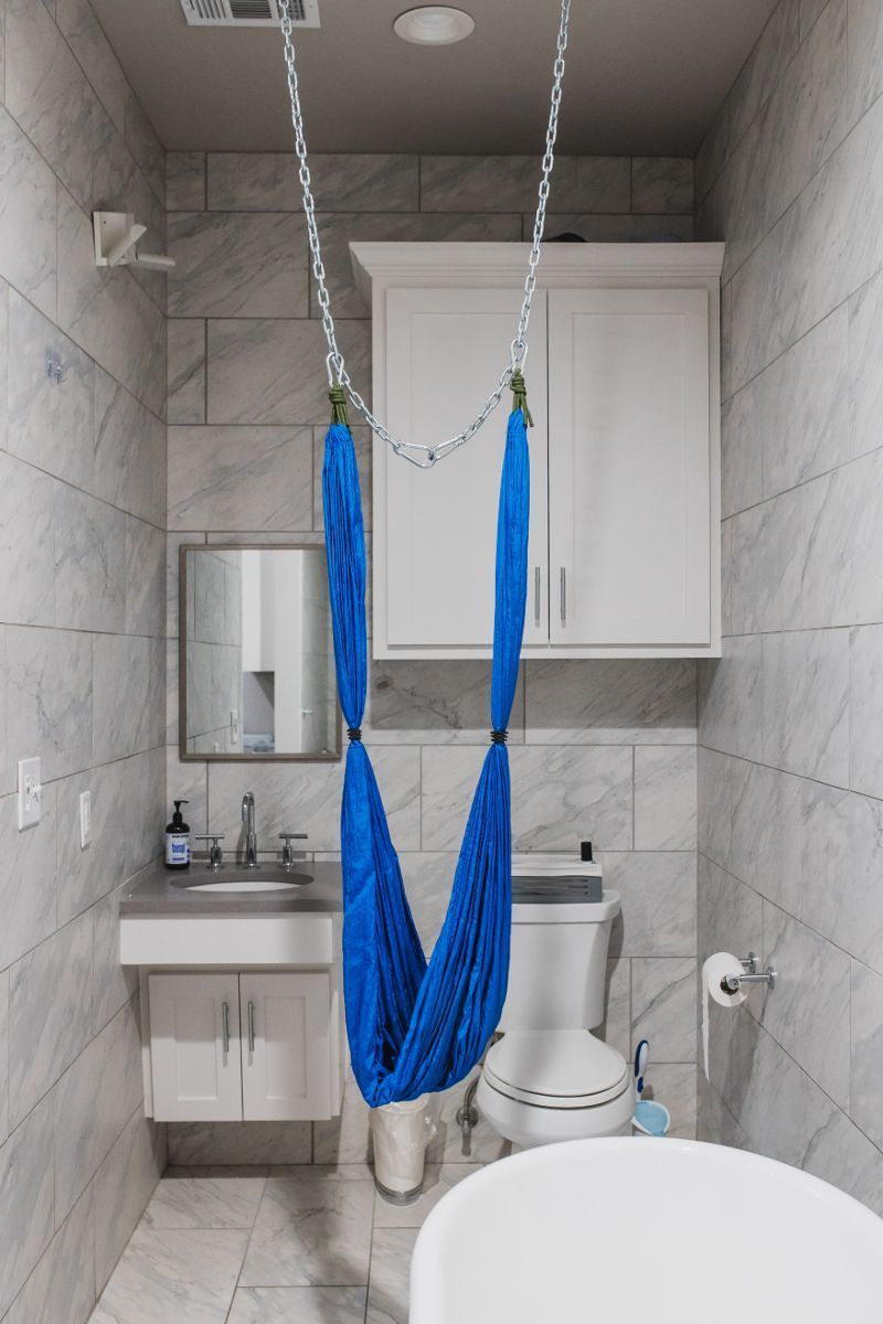 A bathroom with a blue hammock hanging from the ceiling