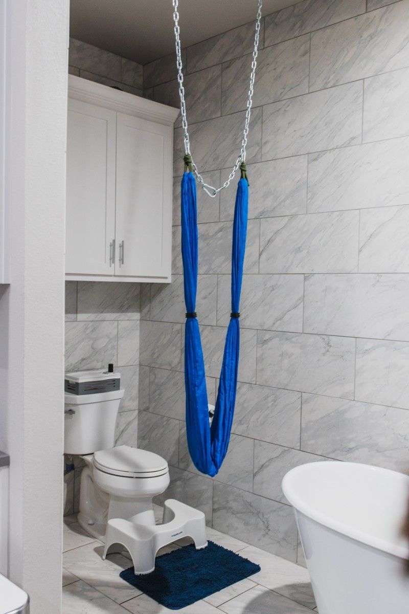 A bathroom with a blue hammock hanging from the ceiling