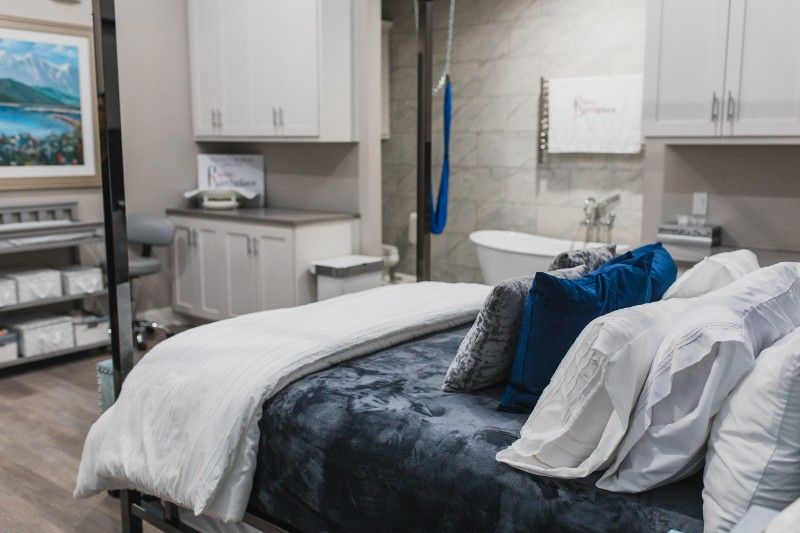 A bedroom with a bed and a bathtub in it.