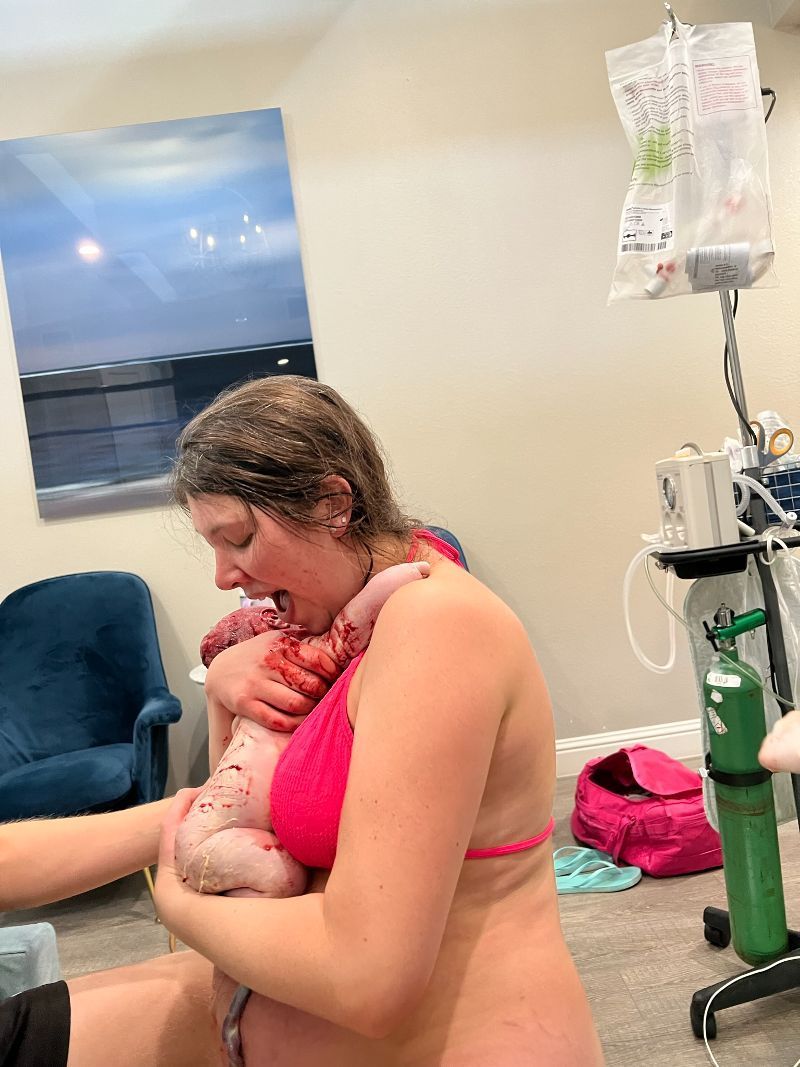 A woman hugging her baby after giving birth