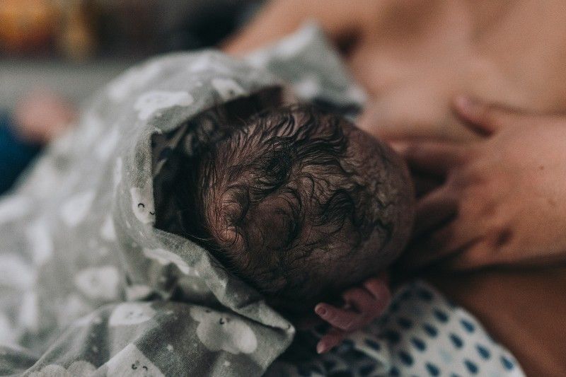 A woman breast feeding her new born baby