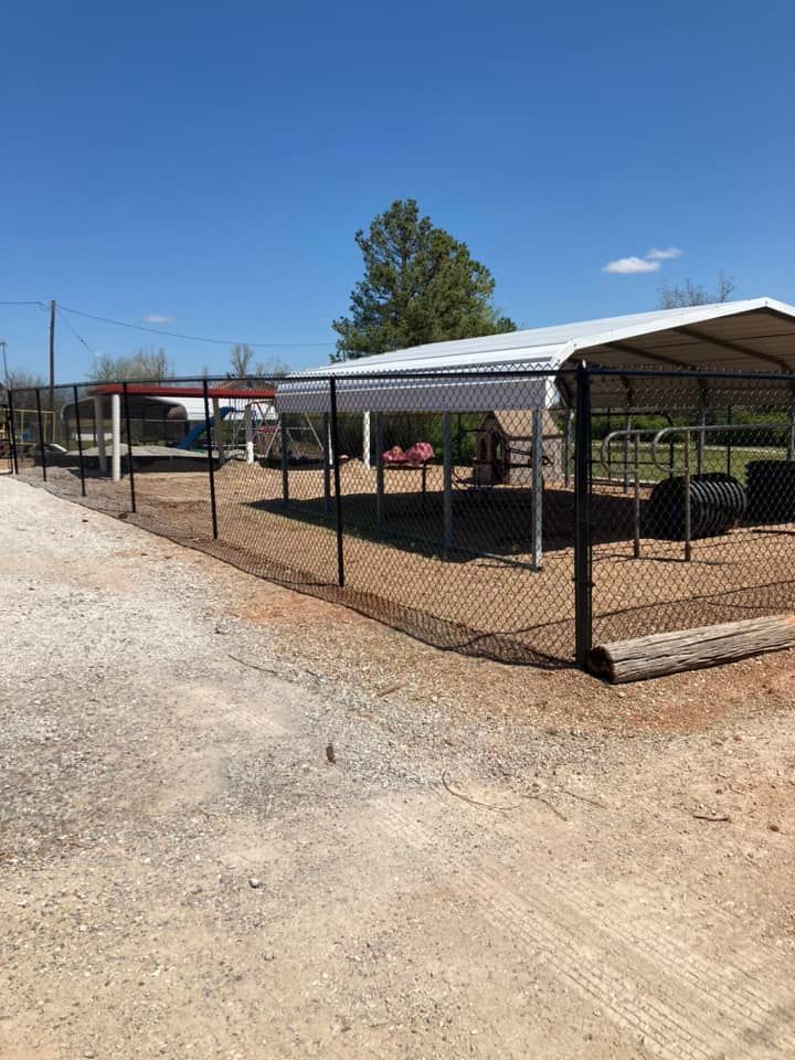 A fenced in area with a canopy and a chain link fence.