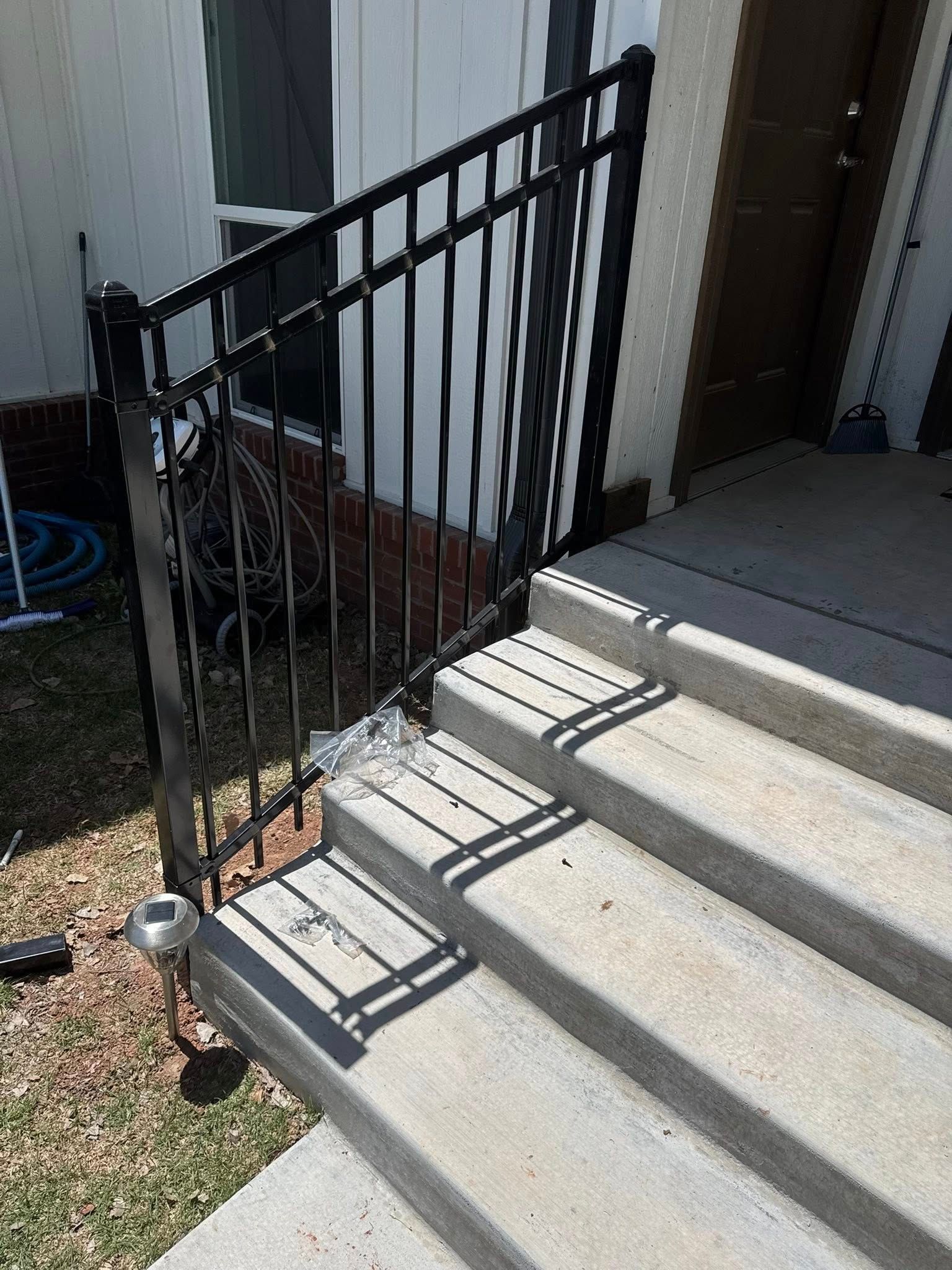 A set of stairs with a wrought iron railing.