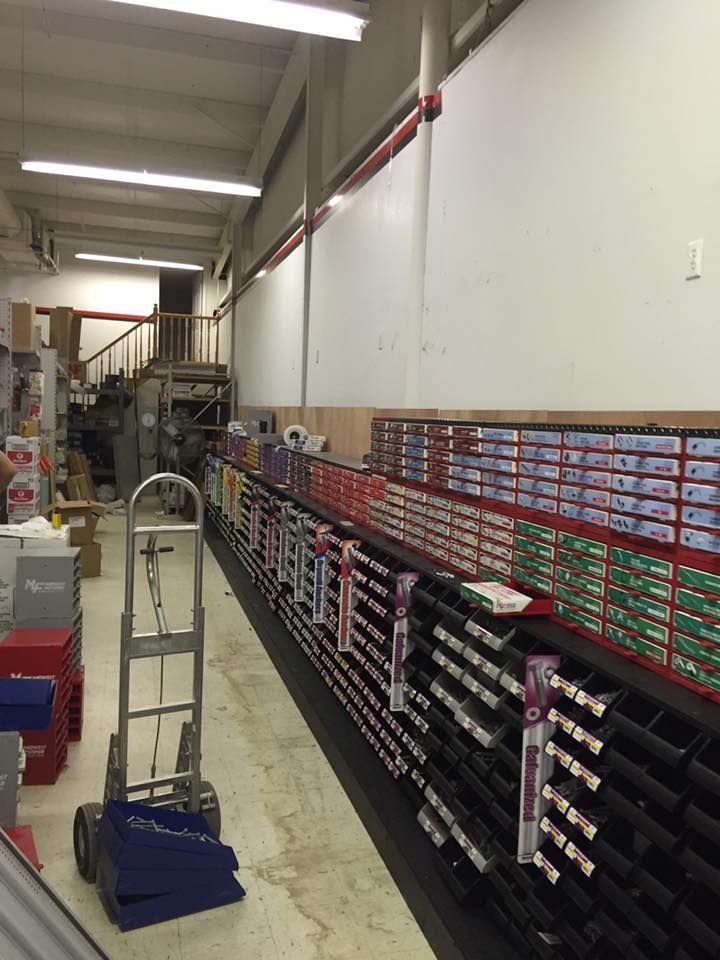 A warehouse filled with lots of boxes and a hand truck