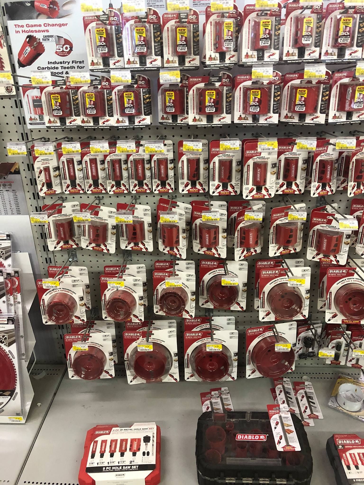 A store shelf filled with lots of red and white products.