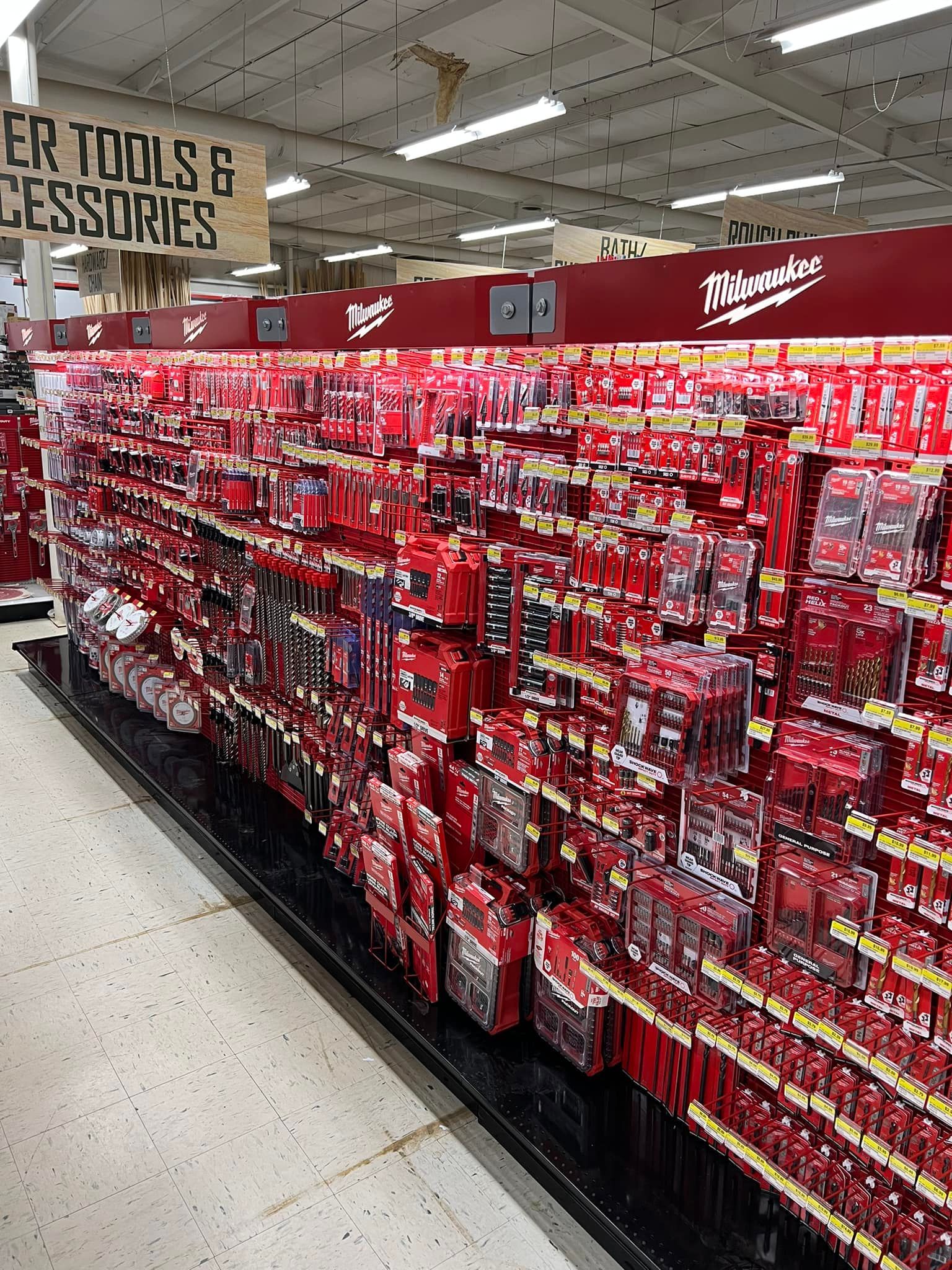 A store aisle filled with lots of red tools and accessories.