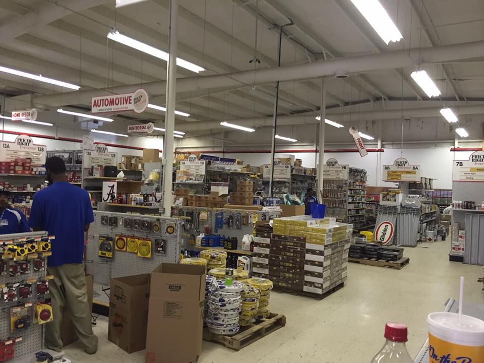 A man in a blue shirt is standing in a hardware store