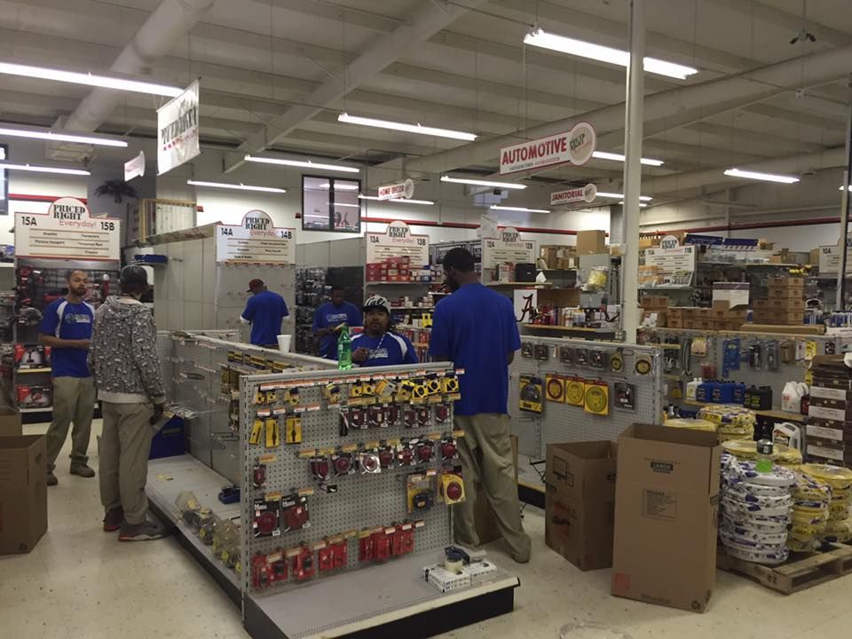A man in a blue shirt is standing in a hardware store