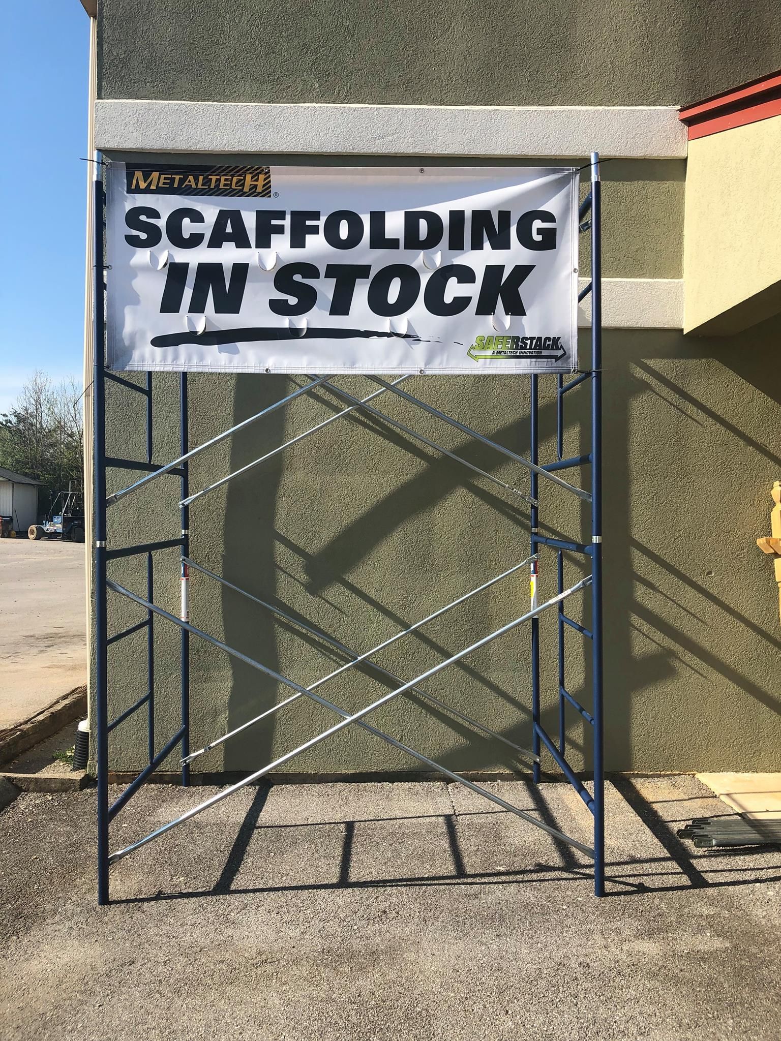A scaffolding is in stock on the side of a building.