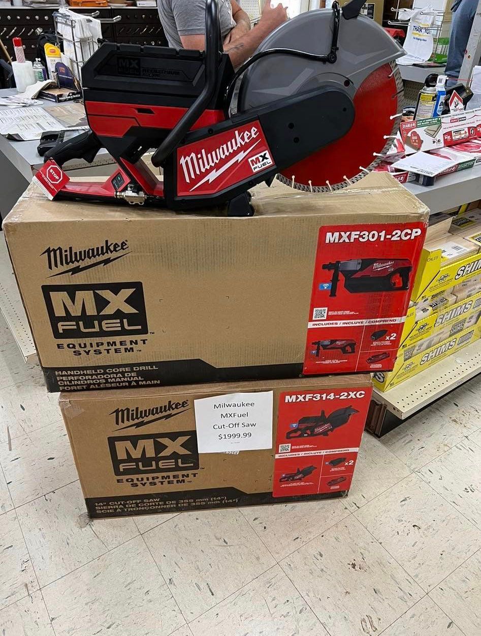 Two boxes of milwaukee mx fuel tools are sitting on top of each other on a table.