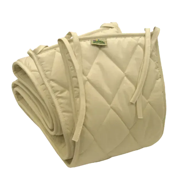 Beige quilted crib bumper with ties, folded.