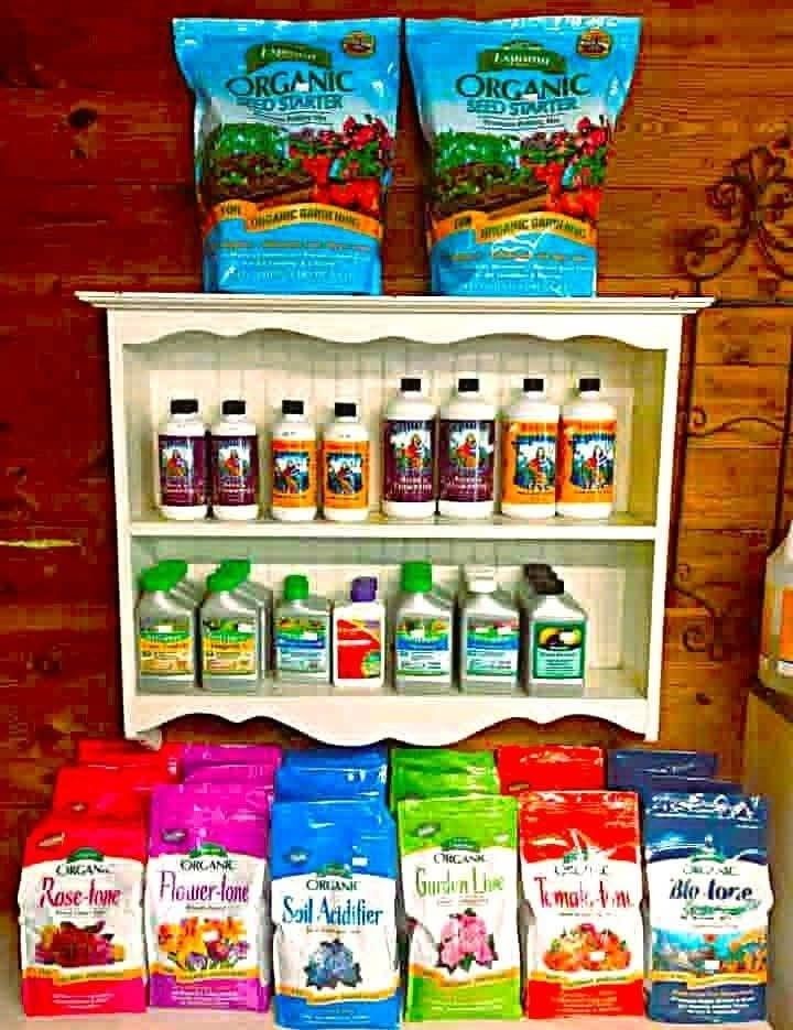 Shelf of colorful organic food products and seed packets displayed against a wooden background.