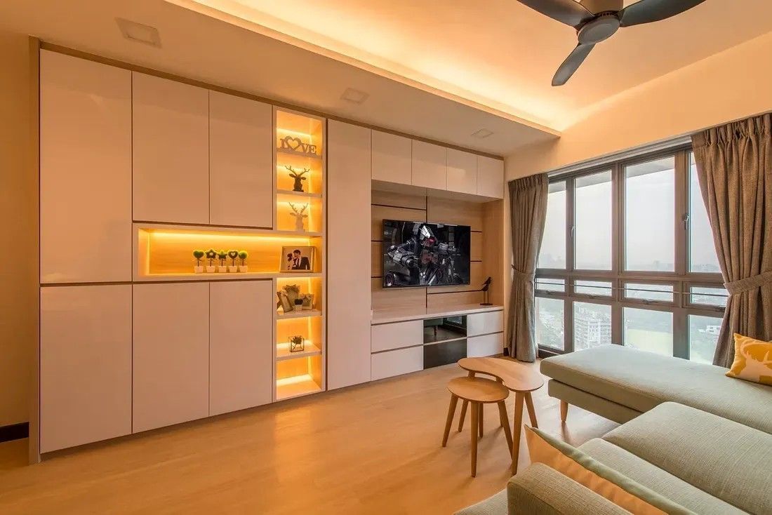 Living room with white cabinets, a TV, and a green sofa.