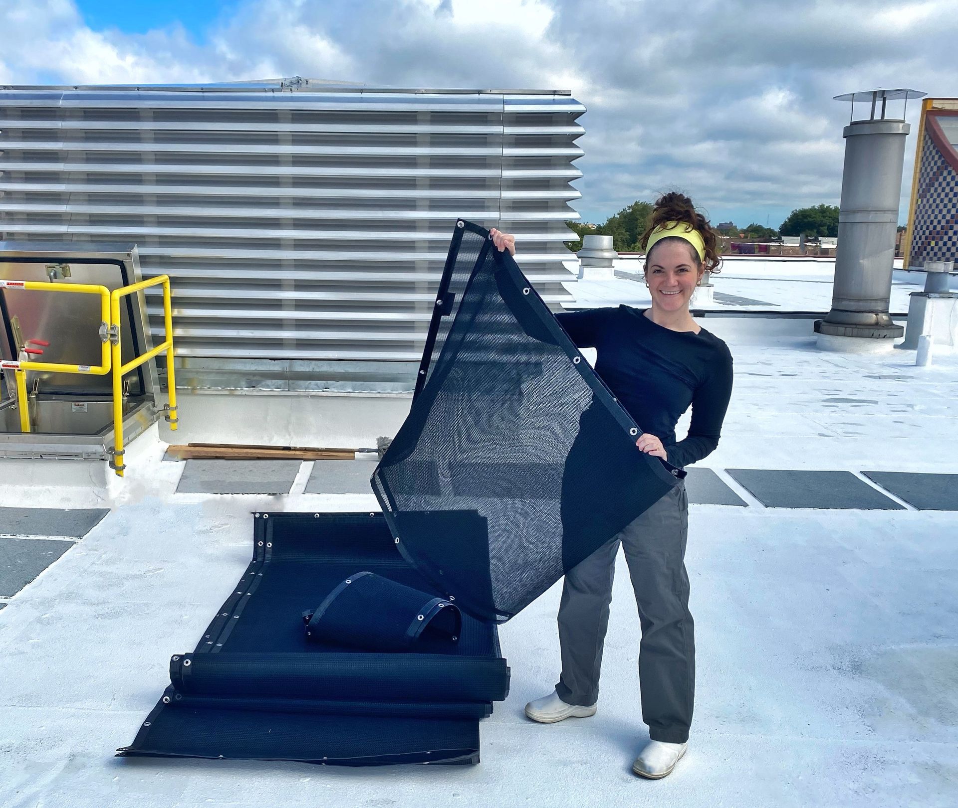 A black and white air conditioner is sitting on a white surface.