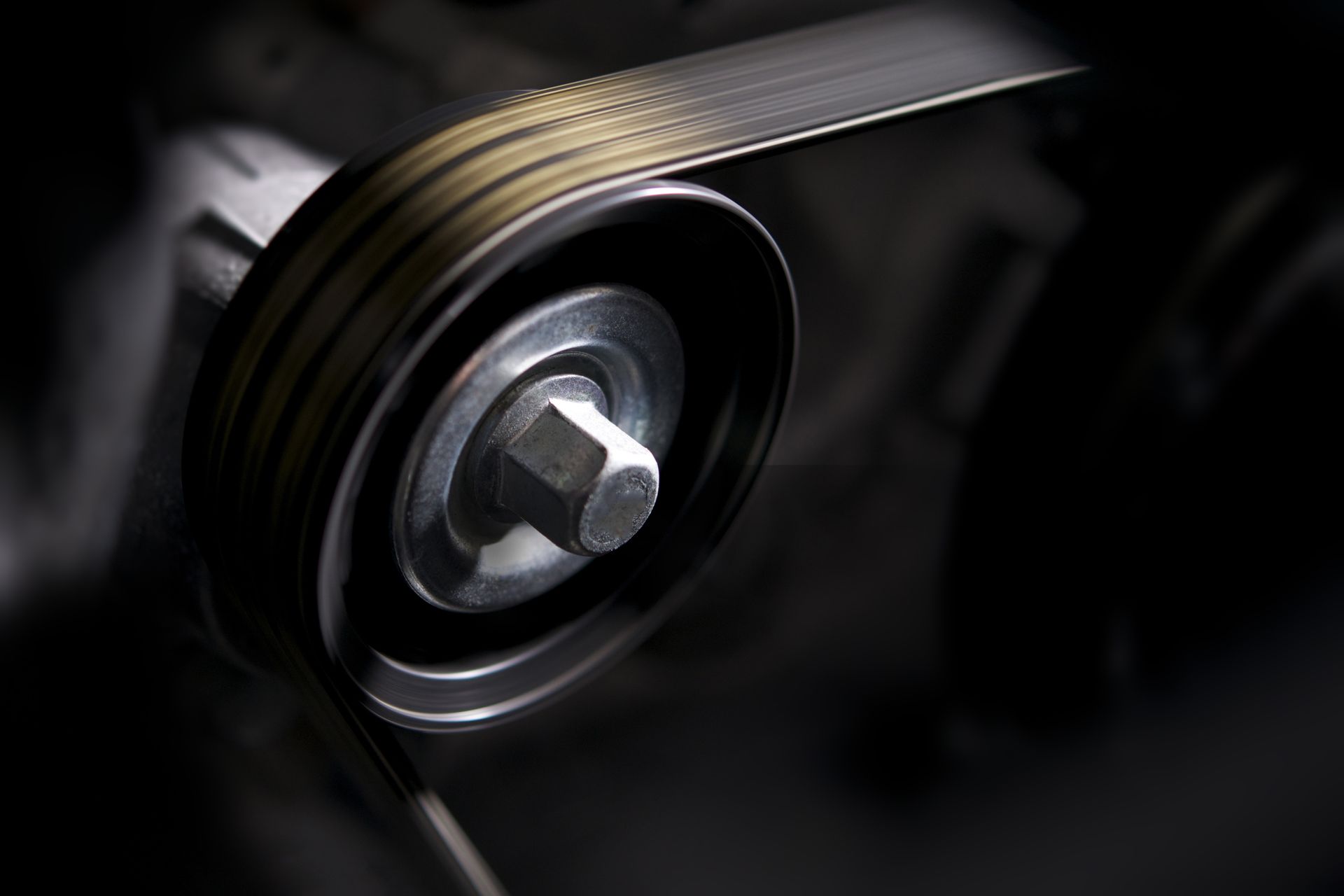 A close up of a drive belt on a black background