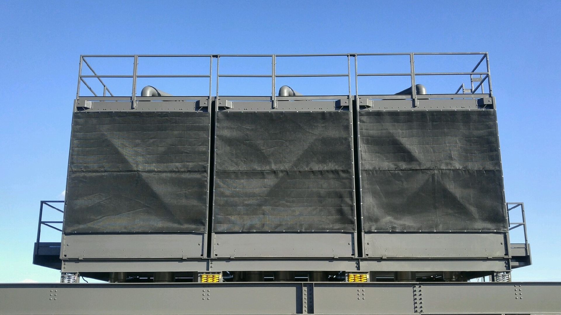 A commercial hvac unit with screens covering it.