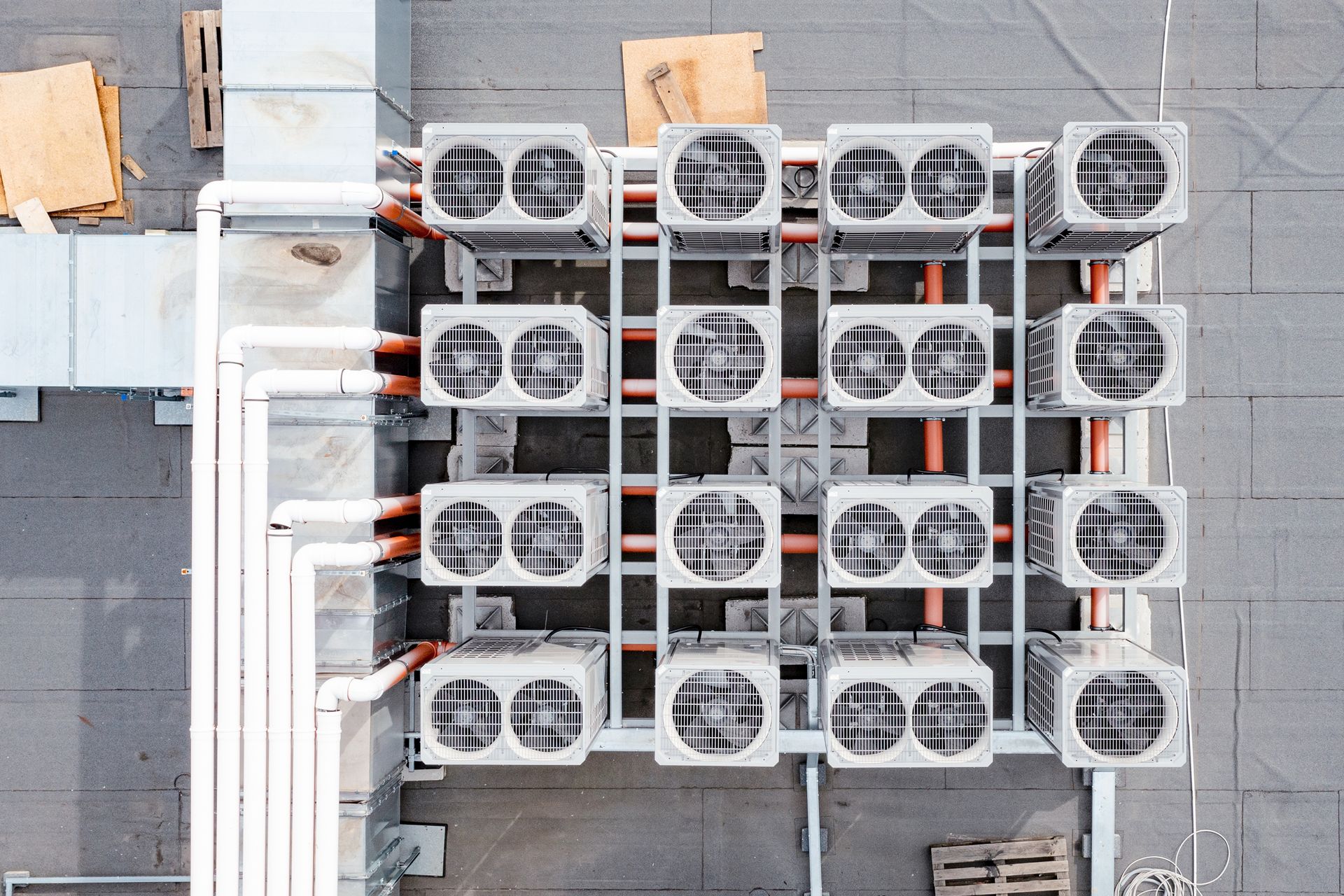 An aerial view of a building with a lot of air conditioners on the roof.